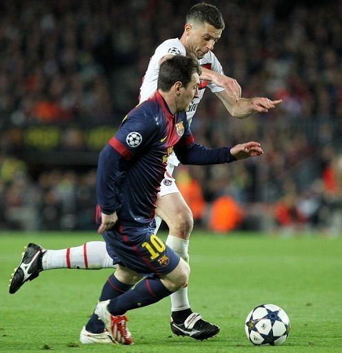 Barcelona's Lionel Messi (L) vies with Paris Saint-Germain's Thiago Motta in Barcelona on April 10, 2013